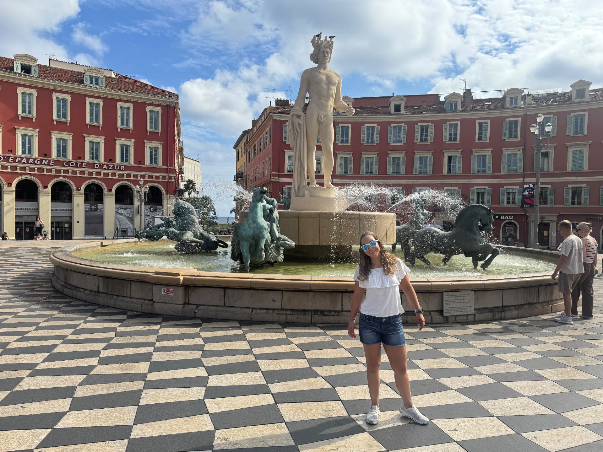 Rox in front of the Fontaine du Soleil and its black-and-white mosaic at Place Masséna.